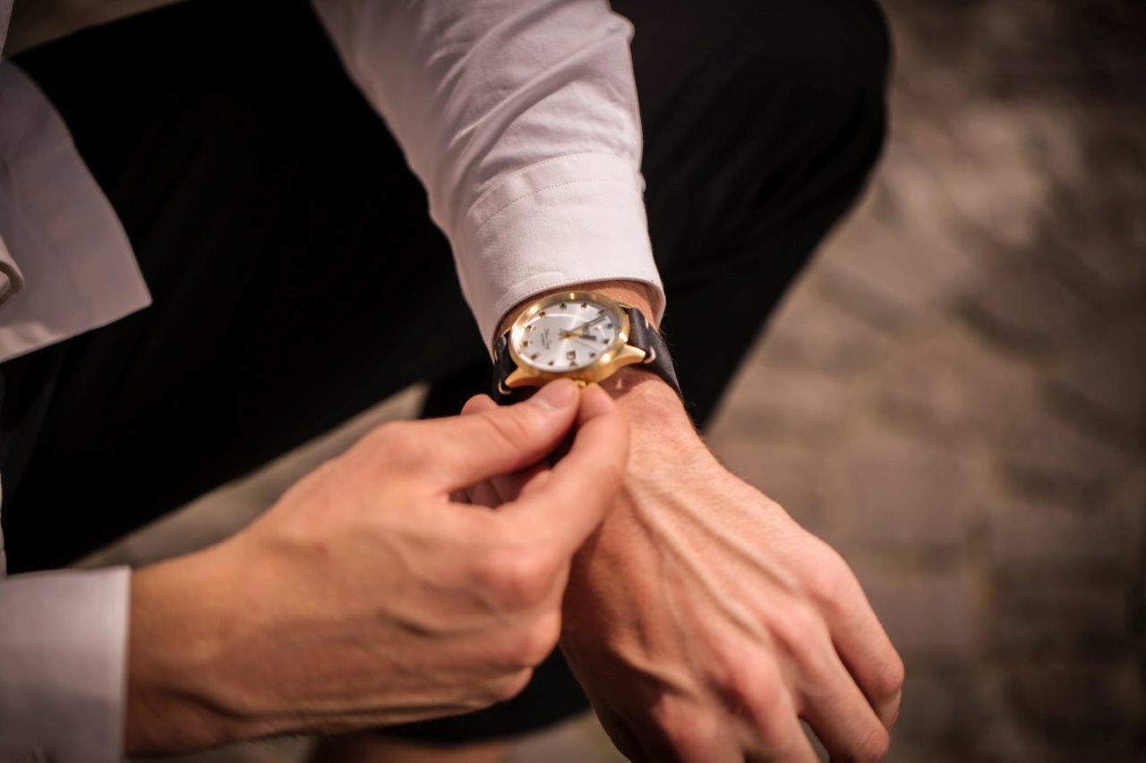 man winding watch on hand